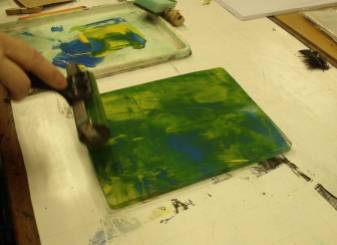 Hand rolling paint onto a gelli plate